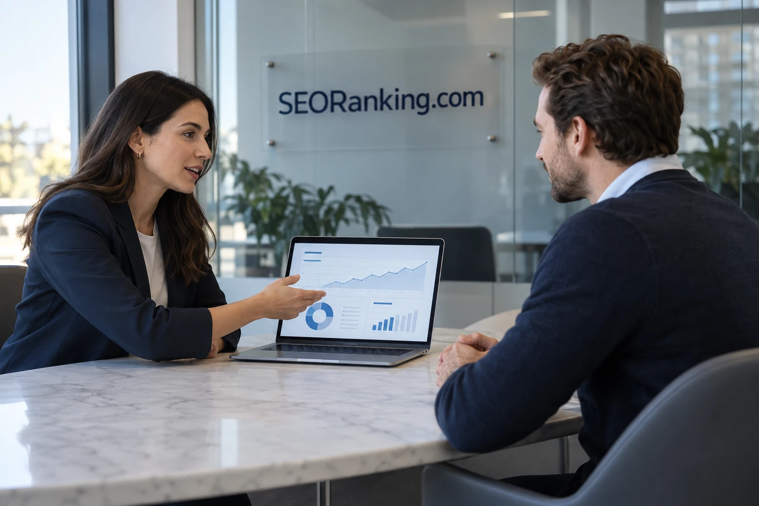 Two colleagues reviewing search reports in an SEORanking.com workspace